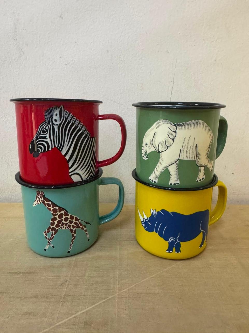 Four hand-painted enamel mugs, each with a different animal: zebra, elephant, giraffe and rhino.
