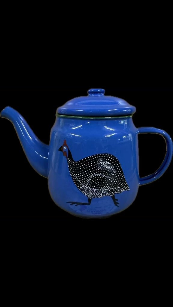 Green hand-painted teapot with a pink flamingo design.